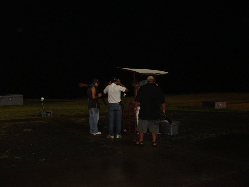 dscf0136r.jpg - Round 13... They're both 500 straight on the day. Bicknell starts on two and Shaeffer on 4. Bicknell mounts his gun and he accidentally fires before calling for the bird. He turns to the official, Rich Latouffe, and says loss. He looks at Shaeffer and tells him its a loss, "Go", he says. Shaeffer shoots at and breaks his next target. Then the officials get together to tell Bicknell it is not a lost bird, to shoot again. At which point, Bicknell comes off the line and tells the official that he feels he deserves a lost target because he accidentally fired due to nerves... really, an unbelievable moment. The officials tell him to shoot the target over, and they both run the trap... they're both 525 straight on the day and heading to the 14th and final round of the shoot off.