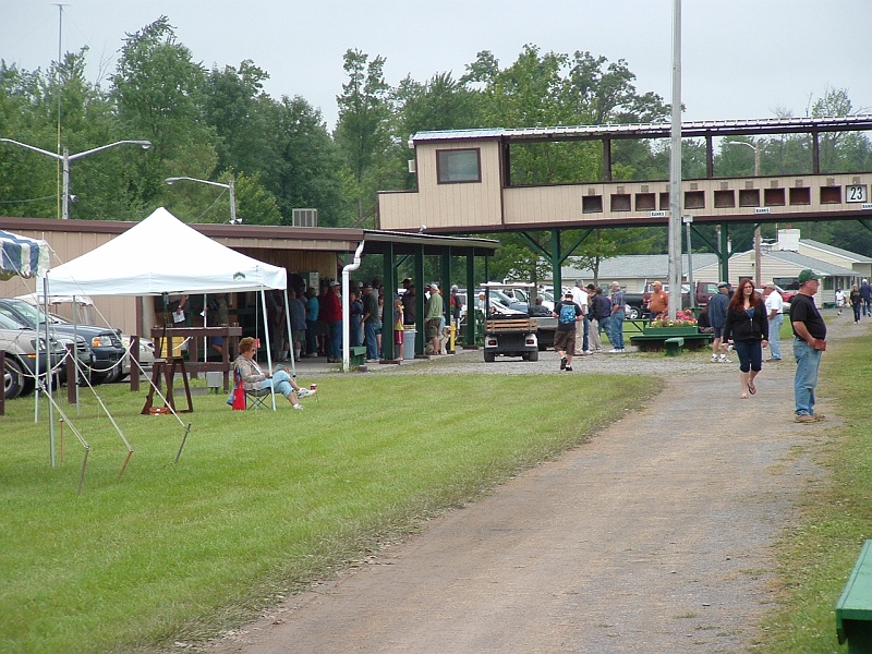 dscf0063d.jpg - This is a shot of the clubhouse and the old bank status board. The folks out front are in line for squadding. To my right is bank 4.